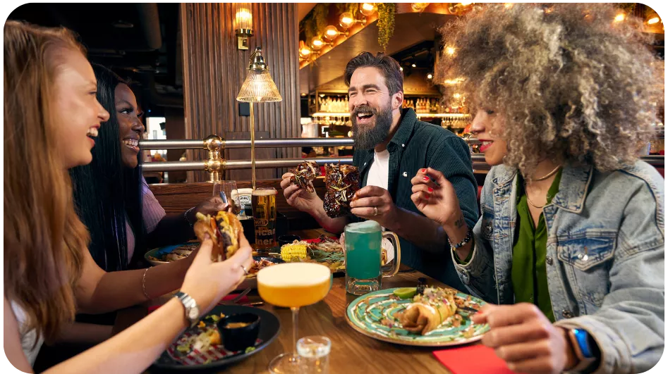 Friends enjoying food and cocktails