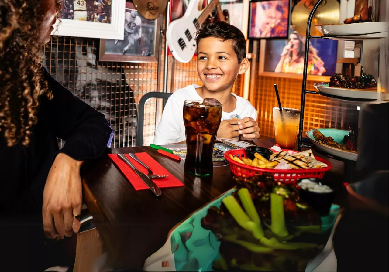 kid at table enjoying meal