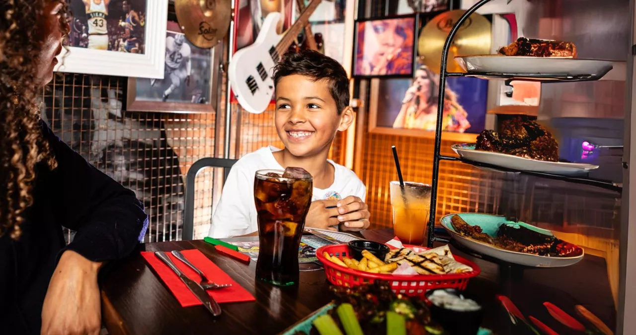 kid enjoying food at table