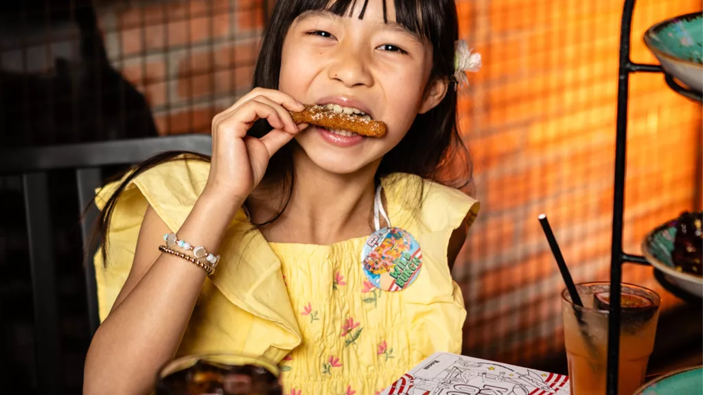 kid at table enjoying meal