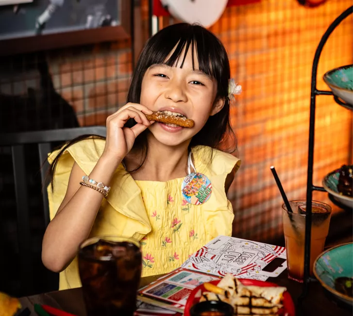 kid at table enjoying meal