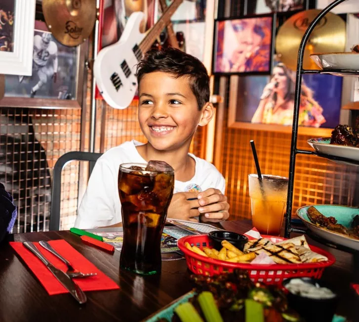 kid enjoying food at table